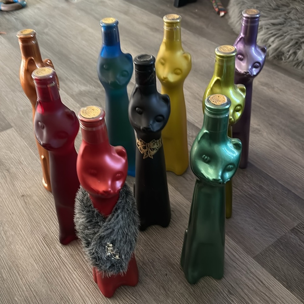 9 unopened bottles of wine in kitty bottles